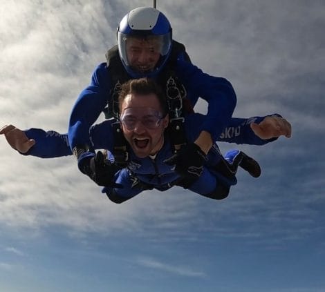 Tandem skydive in progress during charity fundraising event